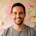 Studio lead smiling beside a project wall covered with milestone notes