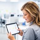 Philadelphia cleaning service manager reviewing appointments in a bright office with a tablet